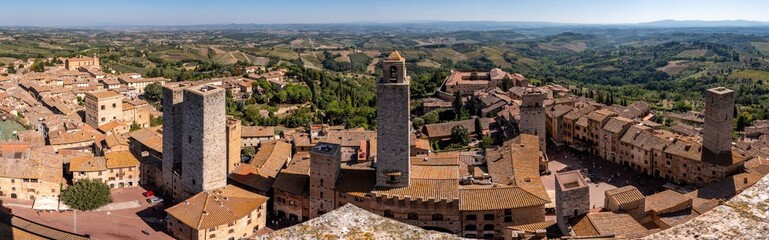 Wide panoramic view over downtown San Gimignano, Torri dei Salvucci and Torre Rognosa in the center, seen from Torre Grosso - obrazy, fototapety, plakaty