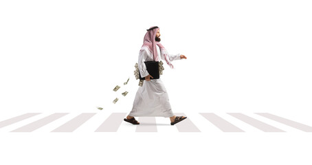 Suadi arab man walking with a briefcase full of money on a pedestrian zebra crossing