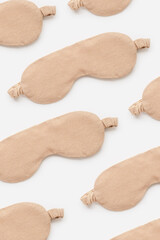 Minimal style pattern made from beige sleeping masks. Woman eye masks for best sleepers, for...