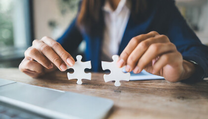 Businesswoman's hand assembles jigsaw puzzle on desk, symbolizing strategy, success, and problem-solving in business - obrazy, fototapety, plakaty