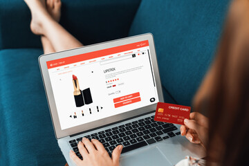 Woman shopping online on internet marketplace browsing for sale items for modern lifestyle and use credit card for online payment from wallet protected by utmost cyber security software - obrazy, fototapety, plakaty