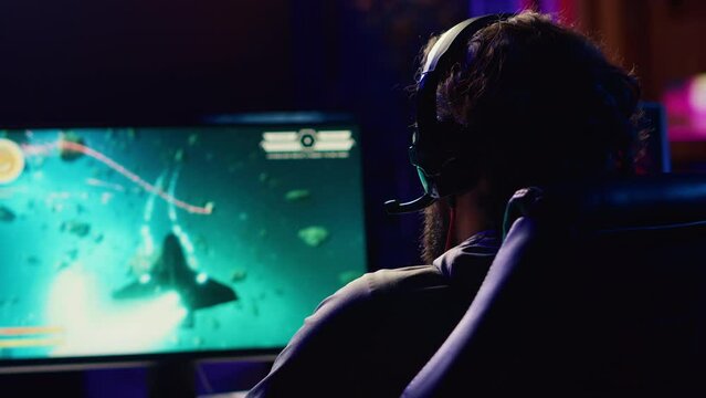 Man talking with friends online, shooting asteroids together in spaceship flying game with overlay HUD showing health, fuel bars. Gamer chatting with teammates while navigating universe in coop game