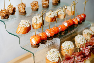 Gourmet Canapes Selection on Glass Platter. An exquisite assortment of canapes, featuring smoked...