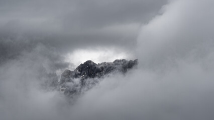 Mountains early morning through dense clouds.