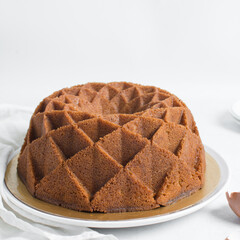 Vanilla bundt cake on a white tray, homemade bundt cake on a white background