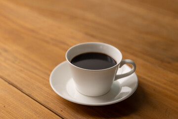 Fototapeta na wymiar Cup of hot coffee on a table,