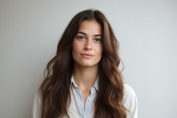 Portrait of beautiful woman with long brown hair looking at camera.