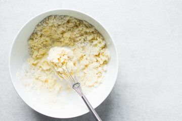 Creaming butter and sugar with a whisk, the process of making cake, mixing butter and sugar to make a cake