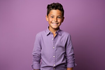 Portrait of a cute little boy in a purple shirt, isolated on purple background