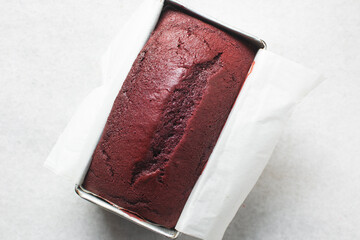 Top view of Red velvet cake in a loaf tin, process of making valentines cake, red velvet loaf cake in a baking tin	