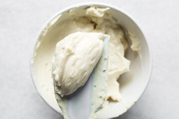 Top view of cream buttercream for decorating cake, silky smooth american buttercream on a spatula, overhead view of smooth buttercream