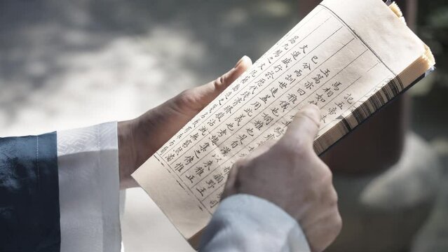 people in ancient costume reading book