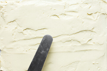 Top view of buttercream for decorating cake, silky smooth american buttercream on a marble surface, overhead view of smooth buttercream