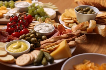 Assorted appetizers served on wooden table, closeup