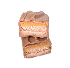 Pieces of tasty chocolate bar with nougat on white background