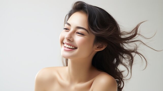 Portrait of a beautiful young Asian woman with long dark hair smiling