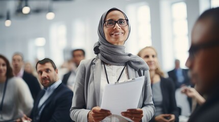 Muslim middle age business woman in front of a group 