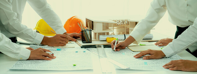 Worker, architect and engineer work on real estate construction project oratory planning with...