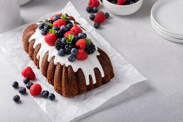 Chocolate cake with vanilla glaze and fresh berries on top