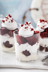 Red velvet cake in a cup, individual dessert idea with cream cheese frosting and whipped cream