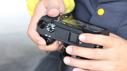 Hand holding a Sony DSLR camera for use