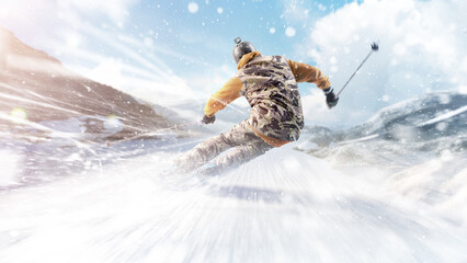 Skis. Skiing Man in action. Back view. Rapid descent at high speed. Skier skiing on a sunny day in...