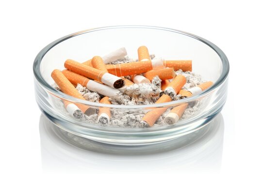 Cigarette stubs in a glass ashtray white isolated