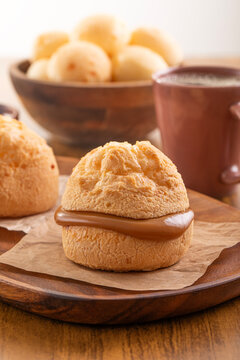 Brazilian snack. P&atilde;o de Queijo filled with dulce de leche. Black coffee. Breakfast.