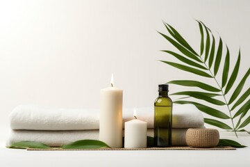 Fototapeta na wymiar Minimalist composition with yoga mat candles and palm leaves on white background Symbolizes healthy lifestyle and home training