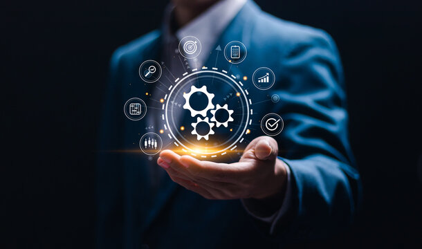 Automation concept. Businessman holding with virtual operations management technology related to business processes and workflows, high performance, monitoring and evaluation.