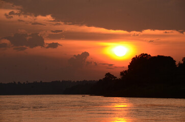 Silhouette tranquil season wilderness serene landscape. Tranquil lake countryside sunrise seaside reflection. Tropical amazing dramatic golden sky on sunset over scenic river lake seascape ocean.