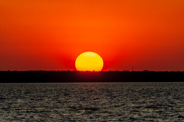Dramatic sunset on the horizon at Cullen Bay, Darwin.
