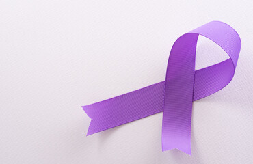 Purple ribbon on white background for supporting World Cancer Day campaign on February 4.