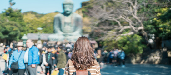Woman tourist Visiting in Kamakura, Kanagawa, Japan. happy Traveler sightseeing the Great Buddha statue. Landmark and popular for tourists attraction near Tokyo. Travel and Vacation concept