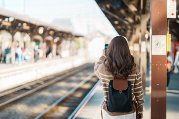 Woman tourist waiting train and Visiting in Kamakura, Kanagawa, Japan. happy Traveler sightseeing...