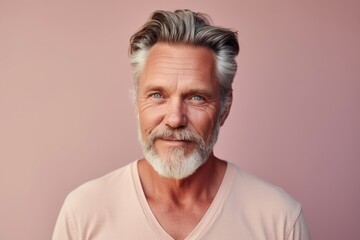 Portrait of a handsome mature man with grey hair and beard.