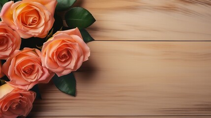 Peach-colored roses laid flat on a light brown wooden table with copy space