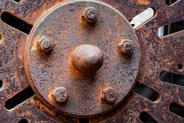 close-up of a rusty chuck on spindle of lathe in abandoned quarry, background of  rust has texture...