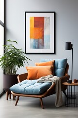 Blue velvet chaise lounge with orange pillows and throw blanket next to tall potted floor plant and black floor lamp