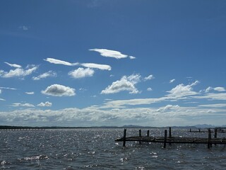 Sail unfurls like a butterfly's wing, slicing through turquoise bliss. Adventure awaits on open waters, where sea and sky meet in an endless