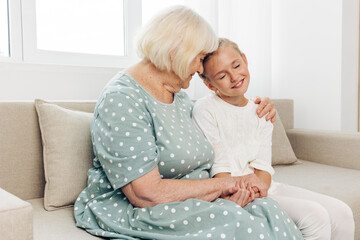 Couch child grandmother sofa family happy hugging love girl home granddaughter
