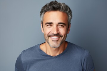 Handsome middle-aged man with grey hair smiling at camera