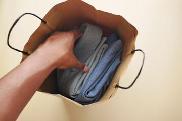 top view of men cloths in a shopping bag 