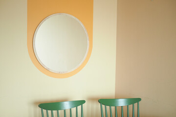 round mirror handing on a wall .