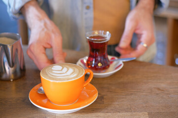 Waitress offering a cup of coffee.
