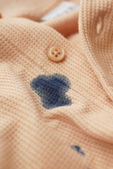  closeup of shirt with blue ink stain .
