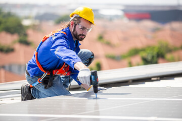 Technicians using electric drill installing and inspecting standards of solar panels on roof of an...
