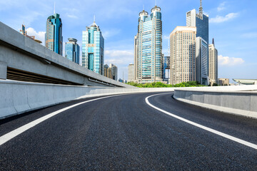 Asphalt road and modern city office buildings under blue sky in Shanghai