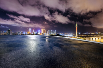 Asphalt road square and city skyline with modern buildings at night in Macau. high angle view.