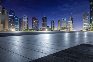 City square floor and modern building scenery at night in Shanghai. Famous financial district...